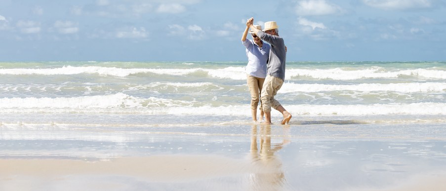 Two seniors dancing in the ocean in Delray Beach, Florida.
